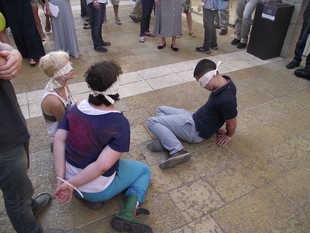 Activists stage street action to protest Israeli torture practices