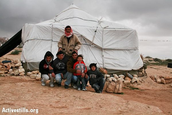 A Palestinian family outside their tent home in the south Hebron Hills village of Susya (Photo: Activestills.org)