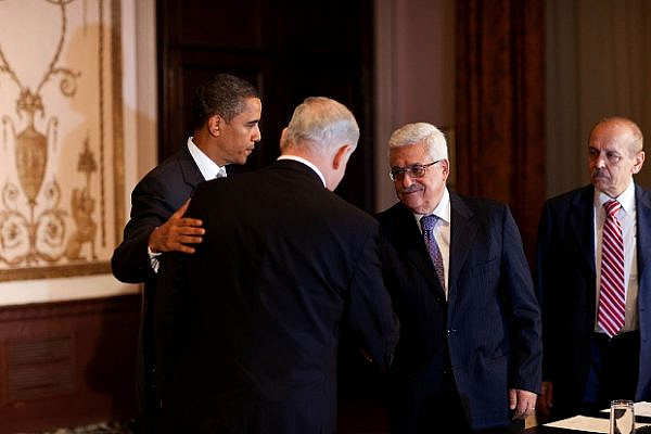 President Barack Obama watches as Israeli Prime Minister Benjamin Netanyahu (left) and Palestinian President Mahmoud Abbas (right) shake hands at a trilateral meeting at the Waldorf-Astoria Hotel in New York, N.Y, Sept. 22, 2009. (Official White House photo by Pete Souza)