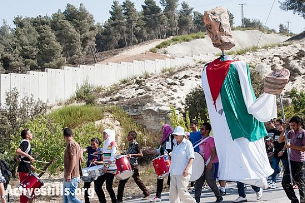 Carrying giant puppets, residents of Al-Walaja, together with Palestinian, international, and Israeli supporters, march through the West Bank village of Al-Walaja to protest the Israeli separation wall, September 28, 2012. If completed as planned, the wall will surround Al-Walaja and cut off its access to surrounding Palestinian communities. (photo: Ryan Rodrick Beiler/Activestills.org)