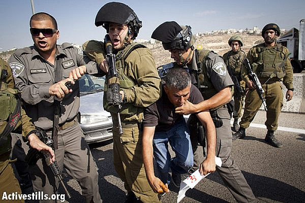 Israeli soldiers arrest Mohammad Khatib of the West Bank village of Bilin, as Palestinian and international activists block Road 443, October 16, 2012. (photo by: Oren Ziv/ Activestills.org)