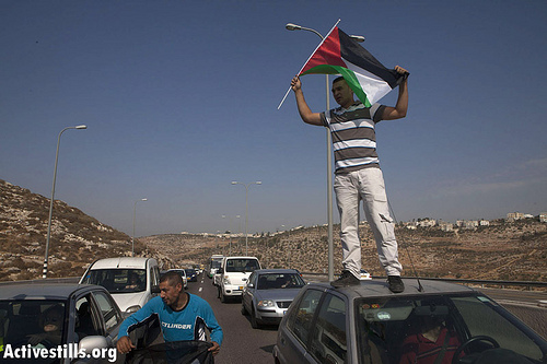 Photos: Palestinians block Route 443 to protest settler violence