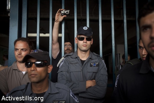 Israeli police officers and private security guards at the entrance to the Jewish settlement of Ma'ale Hazeitim during a demonstration against the settlement in the Arab neighborhood of Ras Al-Amud in East Jerusalem, May, 2011 (photo: Oren Ziv / Activestills)