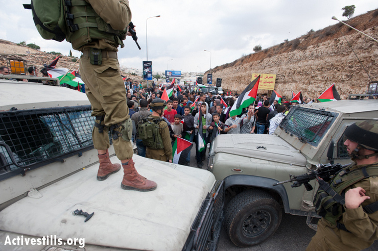 Photos: Palestinians protest occupation, block roads throughout West Bank