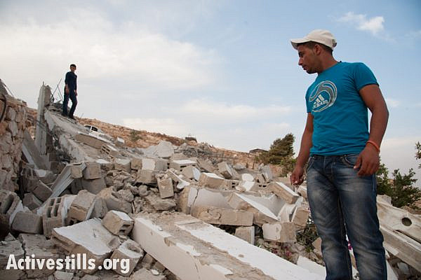 Neighbor Jabril Jahalin, who in July of this year helped to rebuild Beit Arabiya, the family house of Salim and Arabiya Shawamre, surveys the rubble after it was demolished for the sixth time on November 1, 2012. (photo: Ryan Rodrick Beiler/Activestills.org)