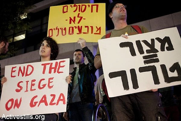 Israelis protest in front of the Tel Aviv residence of the Israeli Minister of Defense, Ehud Barak, against the attack on Gaza on, Tel-Aviv, November 14, 2012. The signs read (from R to L): "Siege=Terror" and "assassinations don't prevent missiles." (photo: Keren Manor/Activestills.org)