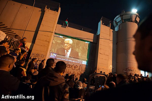 Hundreds of Palestinians gather to watch the speech by President Mahmoud Abbas in the bid for Palestine's "non-member observer state" status at the United Nations, projected on the Israeli separation wall in the West Bank town of Bethlehem, November 29, 2012. Hours later, the UN General Assembly voted 138-9 in favor of the upgraded status for Palestine, with 41 nations abstaining. (photo by: Ryan Rodrick Beiler/Activestills.org)