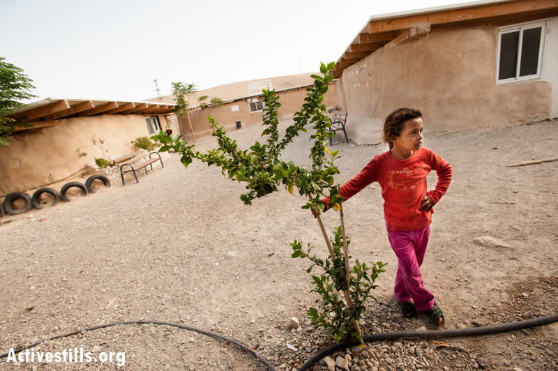A Jahalin Bedouin girl stands near the Khan al-Ahmar Mixed Primary School which is under demolition orders by Israeli authorities. (photo: Ryan Rodrick Beiler/Activestills.org)