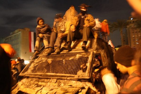 Black Bloc and Tahrir youth celebrate atop a commandeered police truck in the center of the square. (photo: Jesse Rosenfeld)