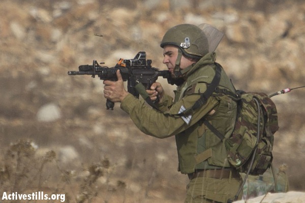 IDF soldier shooting live bullets at demonstrators in Nabi Saleh, November 2, 2012 [illustrative] (Photo: Oren Ziv/Activestills.org)