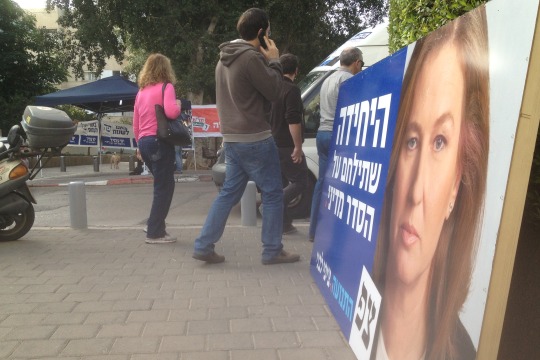 Israelis head to the polls in Tel Aviv amid a sea of campaign posters, January 2013 (photo: Roee Ruttenberg)