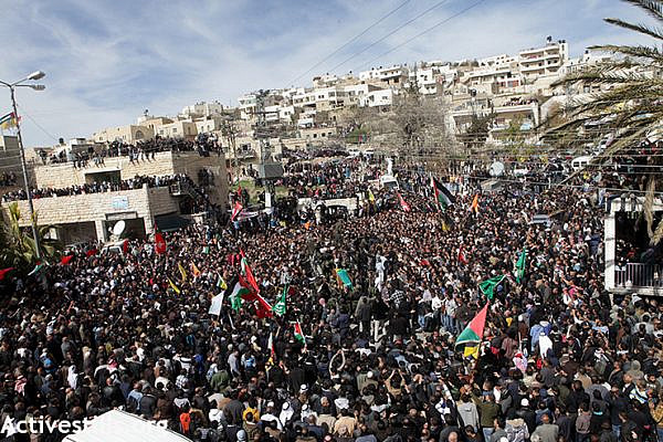 Thousands congregate at the center of  Sa'ir village for the funeral of Arafat Jaradat.