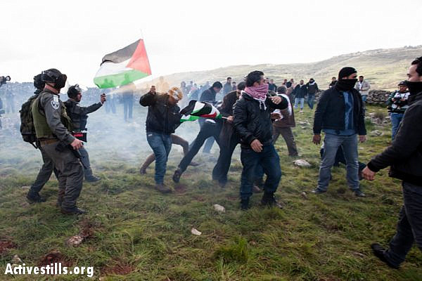 Israeli soldiers use sound bombs and pepper spray to disperse Palestinian activists from a newly created village named Al Manatir on land belonging to the West Bank village of Burin, February 2, 2013. (Photo by: Ryan Rodrick Beiler/Activestills.org)