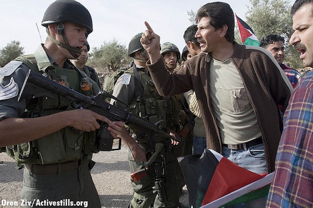 Adeeb Abu Rahme, one of the residents of Bil'in who appears in 5 Broken Cameras, confronts the IDF during a protest in 2007 (Activestills)