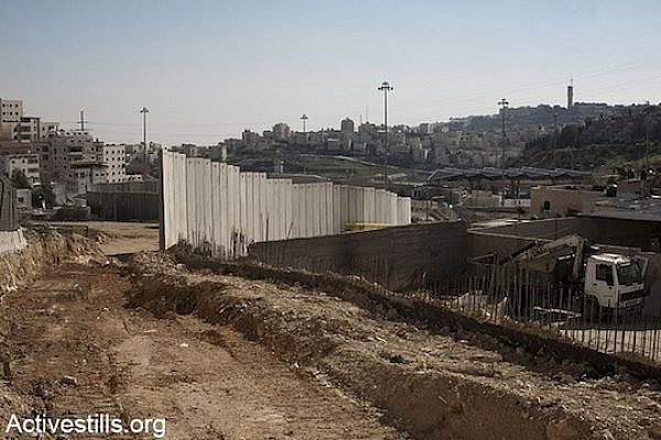 Construction of the separation wall in the Shuafat refugee camp, East Jerusalem, January 19, 2013. (photo: Keren Manor/Activestills)