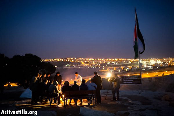 Palestinian activists sit in the new protest camp in the E1 area, West Bank, March 20, 2013. (Photo by: Oren Ziv/Activestills.org)