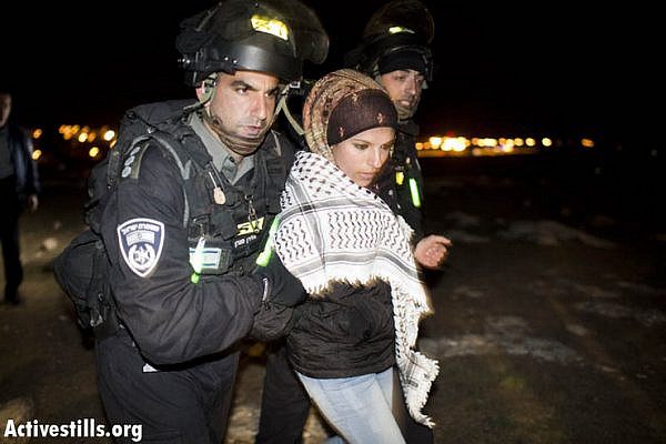Israeli forces arrest an activist as the camp is forcibly evicted.