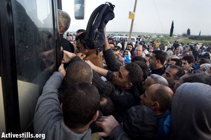 Palestinian workers board a new segregated bus line at the Eyal checkpoint, March 4, 2012.