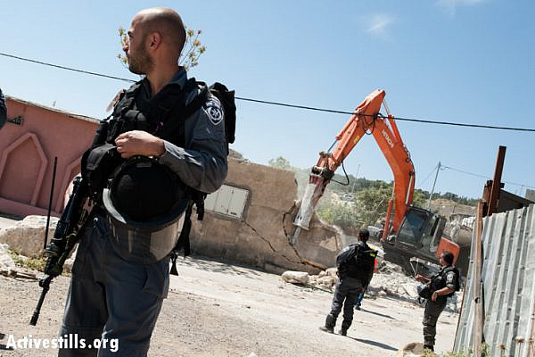 Israeli border police guard for the demolition of the Jaradat family home in the Al Tur neighborhood of East Jerusalem, April 24, 2013. (photo: Ryan Rodrick Beiler/Activestills.org)