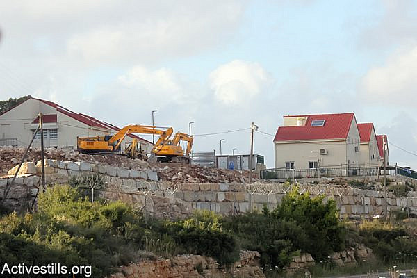 Israeli bulldozers seen in the settlement of Halamish showing the continued building and expansion of the settlement on the lands of the West Bank village of Nabi Saleh, April 19, 2013. (Photo by: Ahmad Al-Bazz/Activestills.org)