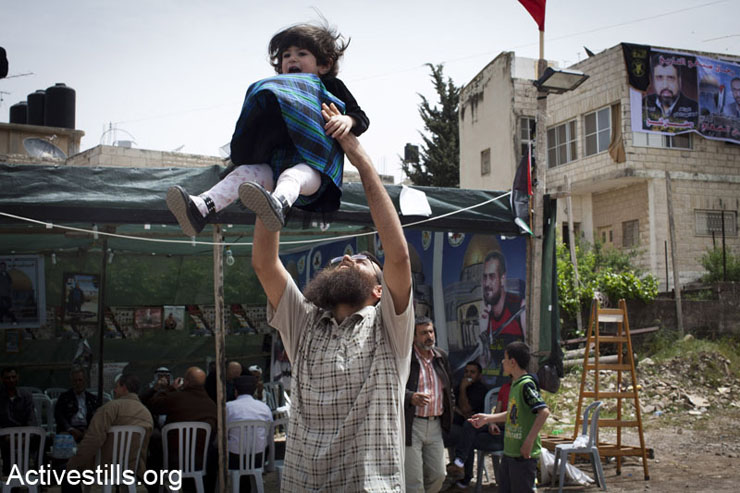 Khader Adnan plays with his daughter on his first day out of Israeli jail in the West Bank village of Araba, near Jenin, April 18, 2012. Israeli authorities released Khader Adnan on April 17, 2012, from administrative detention after he was held in an Israeli jail for four months without trial. Adnan protested his imprisonment and was on hunger strike for 67 days.