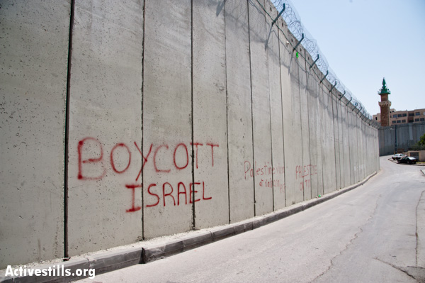 Graffiti on the Israeli separation barrier dividing East Jerusalem neighborhoods reads, "Boycott Israel", March 26, 2012. (photo: Ryan Rodrick Belier/Activestills.org)