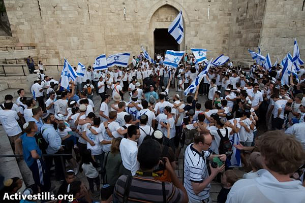 Israeli settlers march into the Old City of Jerusalem during the 'Jerusalem Day' march, East Jerusalem, May 8, 2013. Earlier that day, police forces ordered Palestinian shops and stands inside the Old City to close at 15:00. In previous years, Israeli settlers had vandalized and destroyed many Palestinian shops that remained open during the march. (Photo by: Yotam Ronen/ Activestills.org)