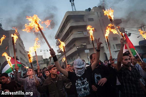 Palestinians march with torches through the streets of Bethlehem to commemorate the Nakba, May 14, 2013. (Photo by: Ryan Rodrick Beiler/Activestills.org)