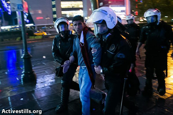 Turkish policemen arrest protesters during clashes following an anti government demonstration, near Kizilay square, Ankara on June 5, 2013.
