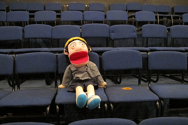 A puppet fills one seat in the empty El-Hakawati Theater on June 27, 2013 in East Jerusalem. The theater would have been filled with children and families, but the Israeli Public Security Ministry canceled the annual festival. (photo: Matt Surrusco, +972 Magazine)