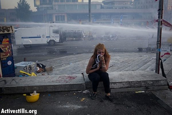 A woman reacts to tear gas, as police evict Taksim Square for the second time on Tuesday. June 11, 2013. (Oren Ziv/Activestills.org)
