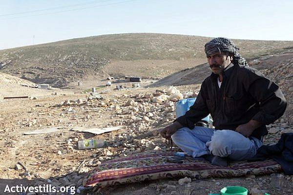 A Bedouin man looking over the ruins of his demolished home. [illustrative photo], (Anne Paq/Activestills)