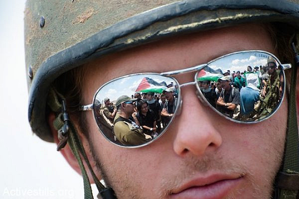 An IDF soldier wearing sunglasses at a demonstration in the south Hebron Hills [file photo], (Ryan Rodrick Beiler / Activestills.org)