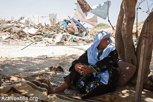 Sanda Abulkian sits outside her demolished house in the "unrecognized" village of Atir on July 12, 2013. Abulkian house was demolished four times already, three of them during 2013. The family has since received a demolition order for the tent in which they live now. (Photo by: Keren Manor/Activestills.org)