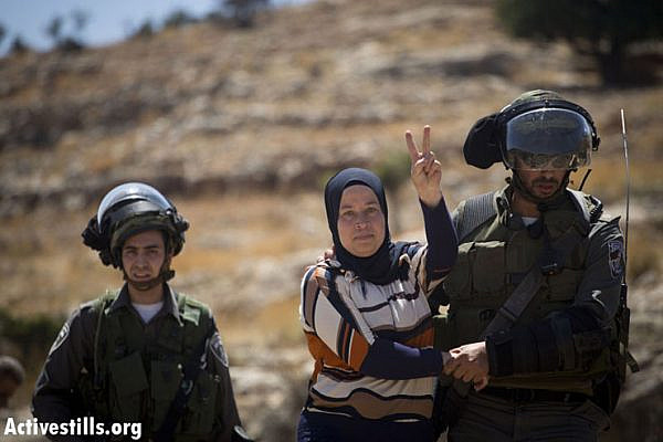 Israeli border policemen arrest Nariman Tamimi during the weekly protest against the Israeli occupation, in the West Bank village of Nabi Saleh, June 28, 2013. Oren Ziv/ Actviestills.org