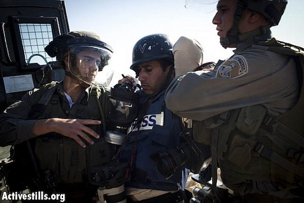 Israeli border policemen arrest AP photographer, Majdi Mohammed, during a protest against the Israel occupation in the West Bank village of Nabi Saleh, December 2, 2011. (Oren Ziv/ Activestills.org)