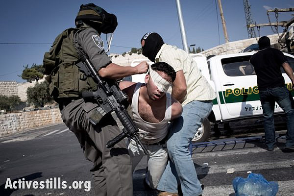 Israeli undercover policeman and a border policeman arrest a Palestinian youth during clashes in the East Jerusalem neighborhood of Ras al Amud, September 27. Clashes broke out in different location in Jerusalem after Israeli police limited the accesses to the Friday prayers in Al Aqsa Mosque. (photo: Oren Ziv/Activestills.org)