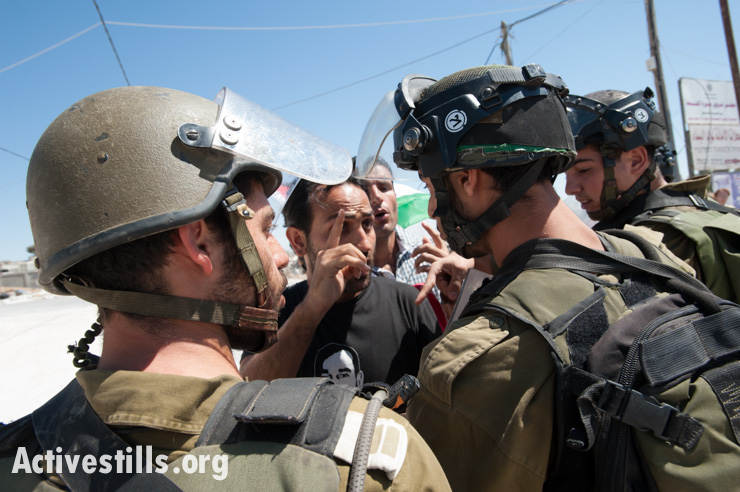 PHOTOS: Israeli army arrests Palestinian activist at nonviolent demonstration