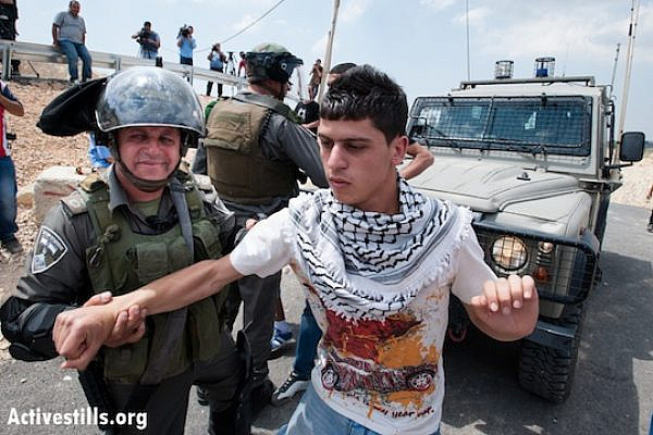 Israeli forces arrest a Palestinian youth in the village of al Walaja (Ryan Rodrick Beiler/Activestills.org)