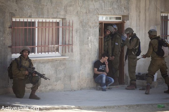 Illustrative photo of Israeli soldiers raiding a Palestinian home and making an arrest in 2012 (Oren Ziv/Activestills.org)