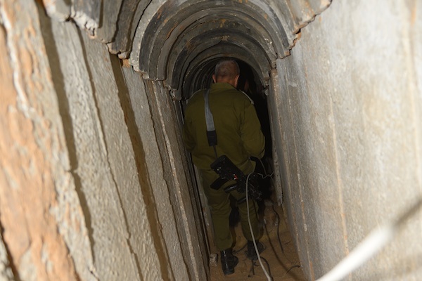An IDF soldier walks through the tunnel the IDF uncovered underneath the Gaza-Israel border earlier this week. (Photo: IDF Spokesperson)