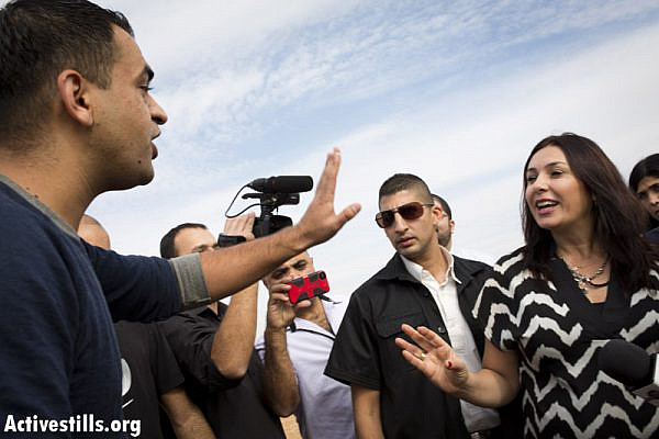 A Bedouin activist argues with MK Miri Regev, during a tour by the Israeli Knesset Internal Affairs Committee in the Negev, regarding the Prawer Plan, in the Bedouin city of Rahat, Novmber 24, 2013.