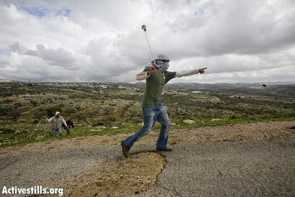 Illustrative photo of a Palestinian youth throwing stones. (Photo: Activestills.org)