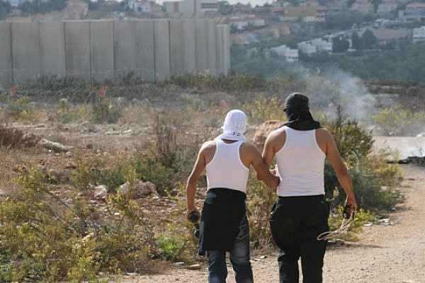 Hand in hand. Bil'iners and the wall (Haggai Matar)