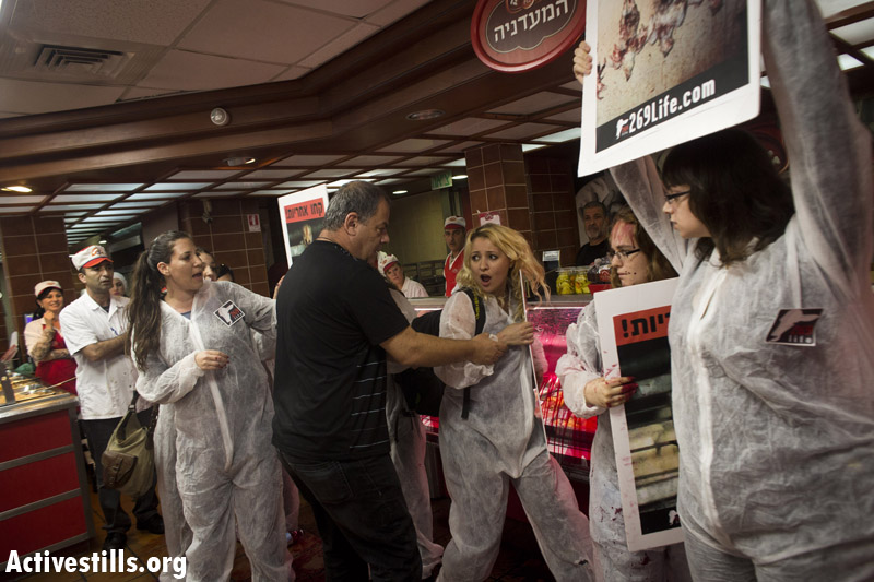 PHOTOS: Animal rights activists arrested in Israeli meat factory store