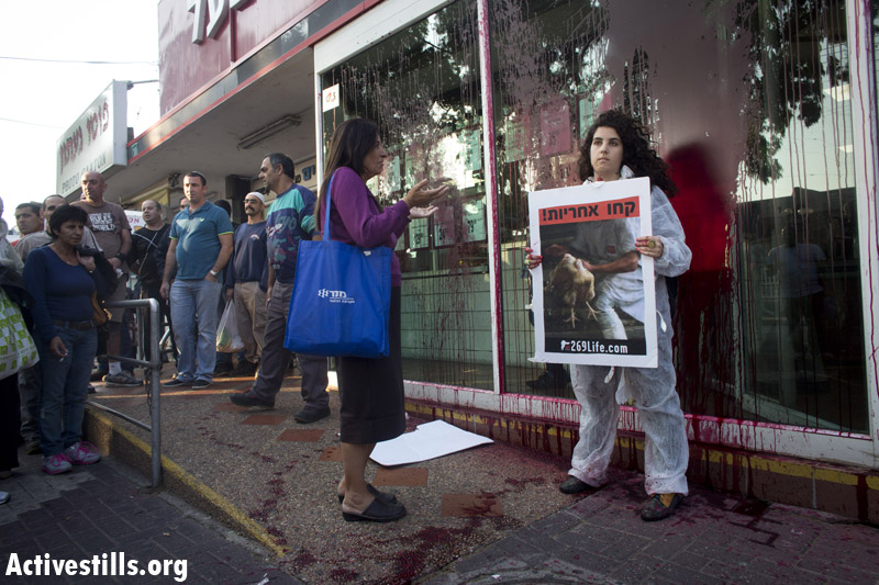 PHOTOS: Animal rights activists arrested in Israeli meat factory store