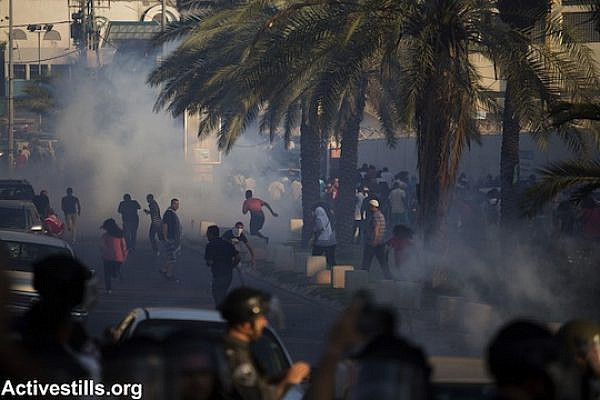 Israeli police fire tear gas toward and forcefully disperse demonstrators during a protest against the Israeli government's Prawer-Begin Plan, on road 65 near the northern town of Ar'ara. (Photo: Activestills.org)
