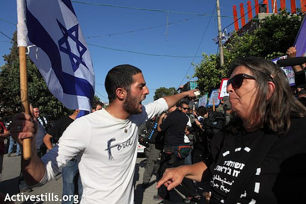 A right-wing Israeli activist yells at a left-wing Israeli activist in East Jerusalem. (Photo: Anne Paq/Activestills.org)