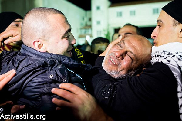 Freed Palestinian prisoners are greeted as they arrive at the Mukata Presidential Compound in the early hours on December 31, 2013 in Ramallah, West Bank.  (Activestills.org)