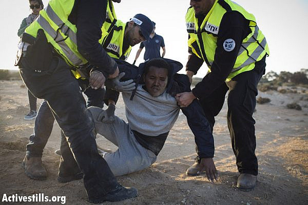 African asylum seeker getting arrested after marching during a second March For Freedom, from Holot detention centre towards Beer Sheva, Negev, December 19, 2013. (Activestills.org)